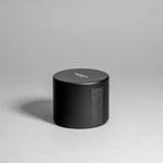 Hinoki candle in a black minimalist tin, featuring a rich, resinous wood aroma with a distinctive brightness. Infused with blue cypress, rose, yuzu, and balanced essential oils for a fresh, welcoming scent. Made with coconut/soy wax, essential oils, and botanical extracts.