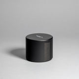 Hinoki candle in a black minimalist tin, featuring a rich, resinous wood aroma with a distinctive brightness. Infused with blue cypress, rose, yuzu, and balanced essential oils for a fresh, welcoming scent. Made with coconut/soy wax, essential oils, and botanical extracts.