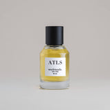 ATLS Atlas 50 mL botanical perfume in a minimalist glass bottle with a matte black cap and golden hue, set against a pale gray backdrop.