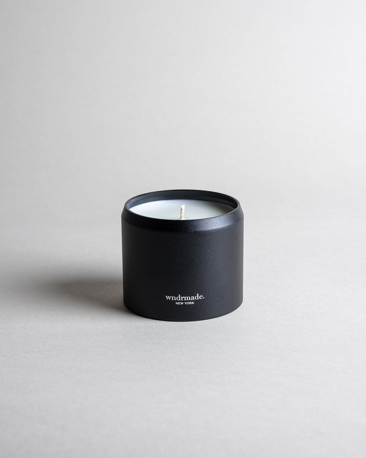 Lavender candle in a black minimalist tin, featuring pure French lavender with a soft, powdery aroma, woody balsamic heart notes, and herbaceous top notes. No synthetics, just the real thing. Made with coconut/soy wax, essential oils, and botanical extracts.