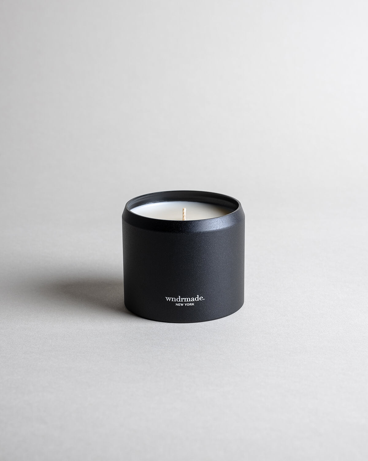 Patchouli candle in a black minimialist tin, crafted with frankincense, juniper berry, jasmine, and more. A deep, sophisticated, and timeless aroma that redefines this enigmatic scent. Made with coconut/soy wax, essential oils, and botanical extracts.