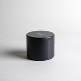 Patchouli candle in a black minimialist tin, crafted with frankincense, juniper berry, jasmine, and more. A deep, sophisticated, and timeless aroma that redefines this enigmatic scent. Made with coconut/soy wax, essential oils, and botanical extracts.