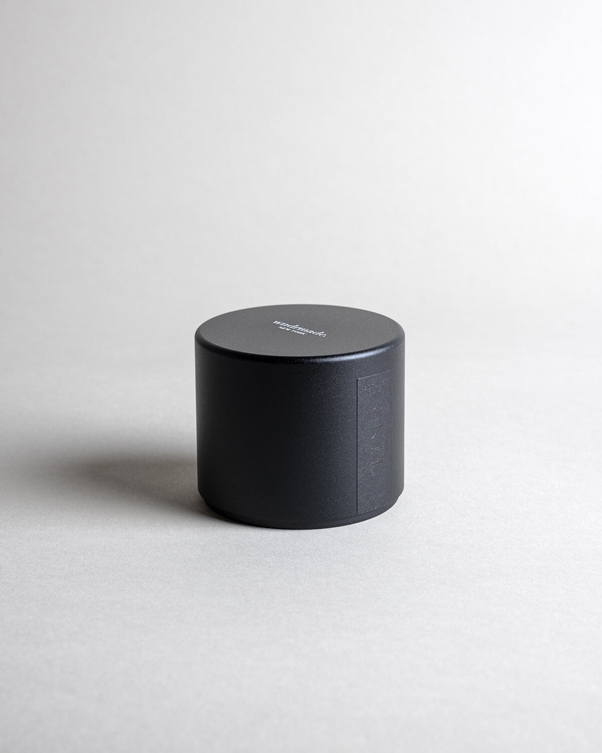 Santalum candle in a black minimalist tin, featuring sweet, rich, and luxurious sandalwood with a silky, smooth aroma. A warm, ethereal fragrance that arouses the senses and evokes timeless memories. Made with coconut/soy wax, essential oils, and botanical extracts.