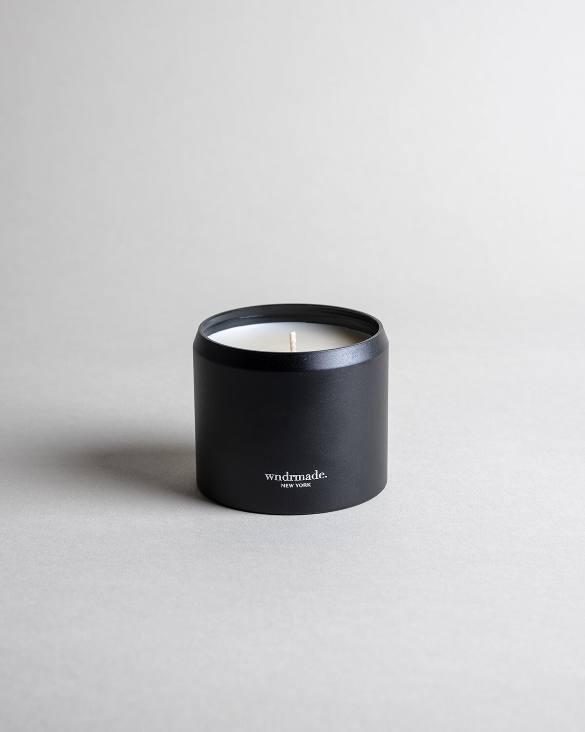 Vanilla candle in a black minimalist tin, featuring a soothing vanilla aroma with spicy, sweet, and complex notes. Ideal for relaxation, reminiscing, and creating a warm sense of home. Made with coconut/soy wax, essential oils, and botanical extracts.