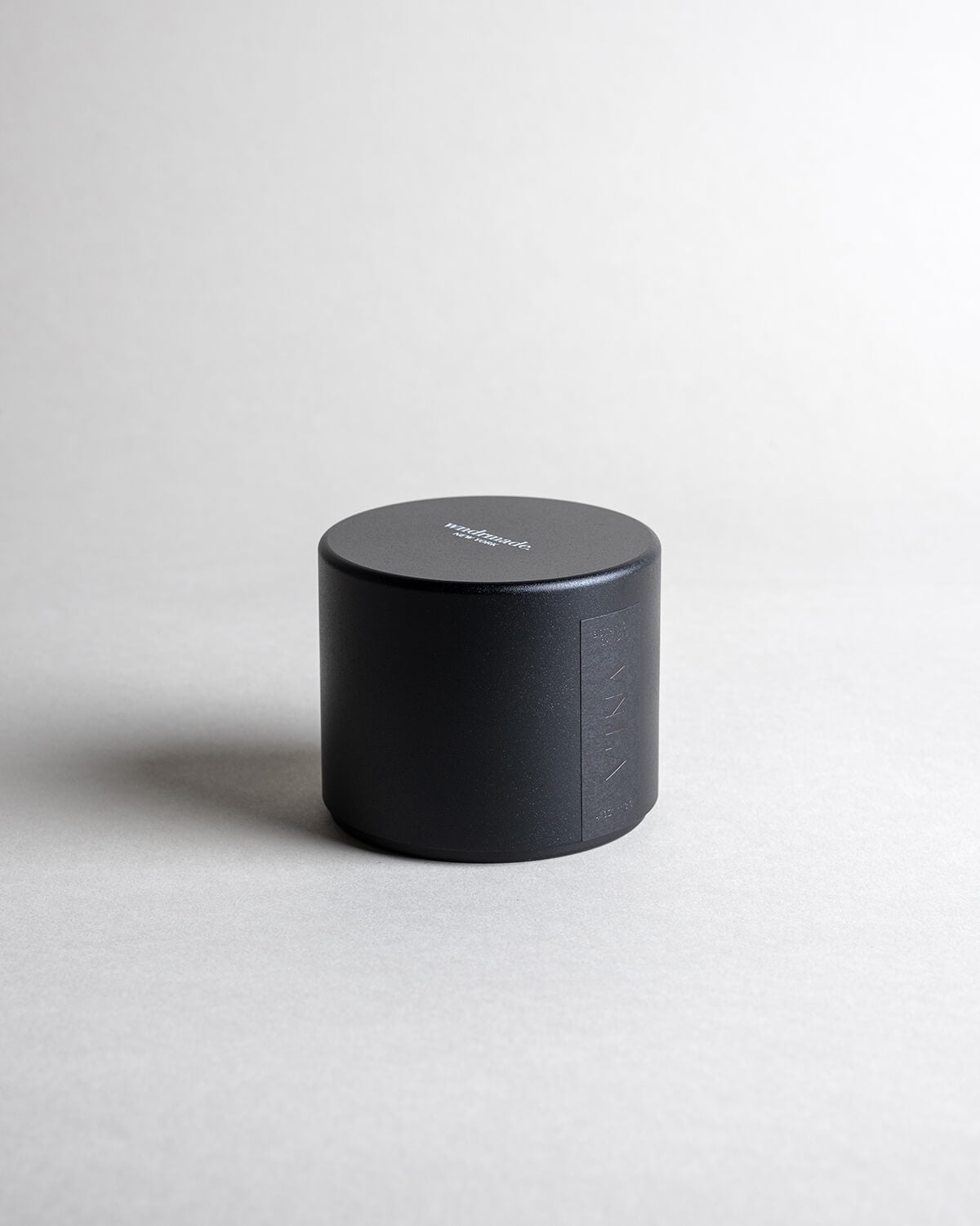 Vanilla candle in a black minimalist tin, featuring a soothing vanilla aroma with spicy, sweet, and complex notes. Ideal for relaxation, reminiscing, and creating a warm sense of home. Made with coconut/soy wax, essential oils, and botanical extracts.