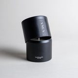 Vanilla candle in a black minimalist tin, featuring a soothing vanilla aroma with spicy, sweet, and complex notes. Ideal for relaxation, reminiscing, and creating a warm sense of home. Made with coconut/soy wax, essential oils, and botanical extracts.