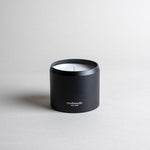 ATLAS candle in a black minimalist tin, evoking a dreamy walk through Moroccan cedar forests with a light citrus blossom breeze. A soft, woodsy, and mildly sweet design, crafted to calm the mind. Made with coconut/soy wax, essential oils, and botanical extracts.