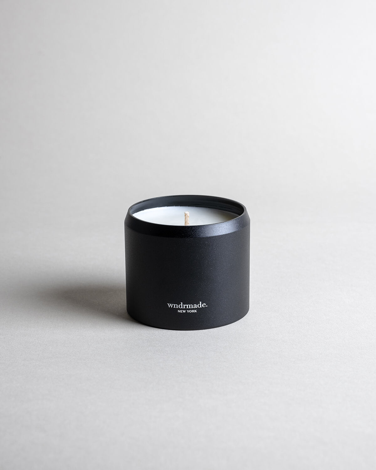 ATLAS candle in a black minimalist tin, evoking a dreamy walk through Moroccan cedar forests with a light citrus blossom breeze. A soft, woodsy, and mildly sweet design, crafted to calm the mind. Made with coconut/soy wax, essential oils, and botanical extracts.