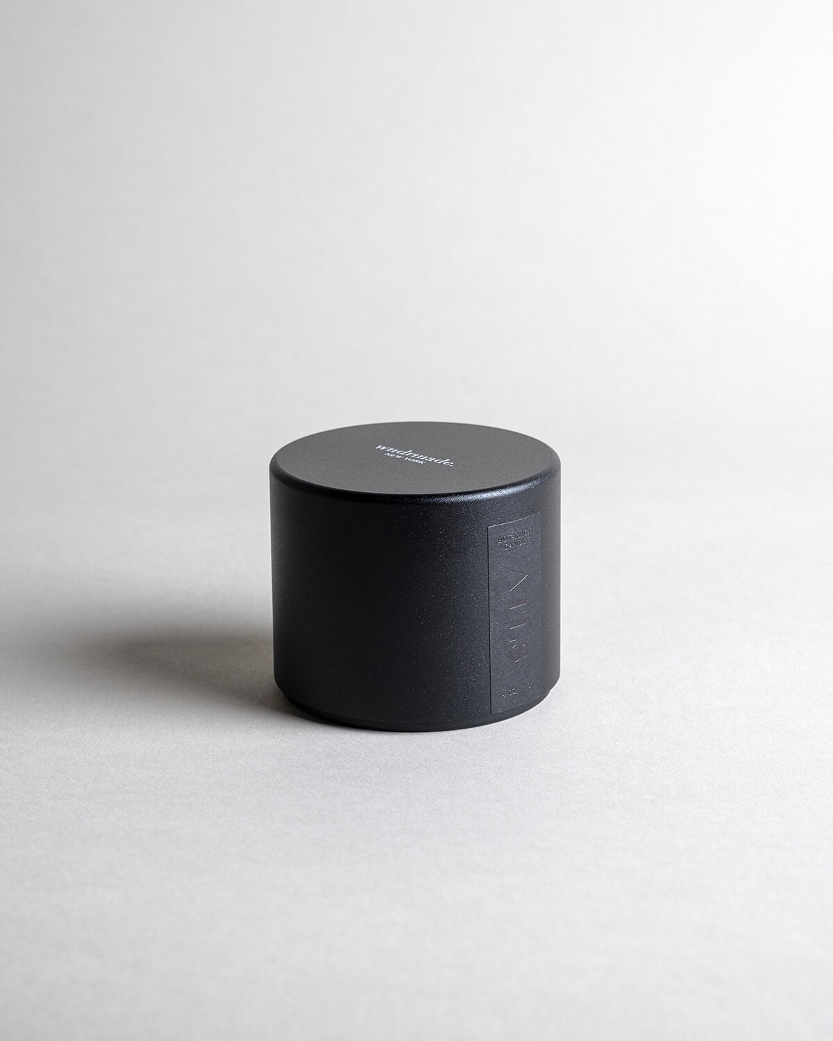 ATLAS candle in a black minimalist tin, evoking a dreamy walk through Moroccan cedar forests with a light citrus blossom breeze. A soft, woodsy, and mildly sweet design, crafted to calm the mind. Made with coconut/soy wax, essential oils, and botanical extracts.