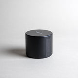 Jasmine candle in a black minimalist tin, featuring a sultry, seductive, honey-sweet aroma with natural complexity. Both arousing and calming, this scent celebrates intimate moments. Made with coconut/soy wax, essential oils, and botanical extracts.