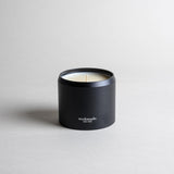 Jasmine candle in a black minimalist tin, featuring a sultry, seductive, honey-sweet aroma with natural complexity. Both arousing and calming, this scent celebrates intimate moments. Made with coconut/soy wax, essential oils, and botanical extracts.