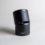 Jasmine candle in a black minimalist tin, featuring a sultry, seductive, honey-sweet aroma with natural complexity. Both arousing and calming, this scent celebrates intimate moments. Made with coconut/soy wax, essential oils, and botanical extracts.