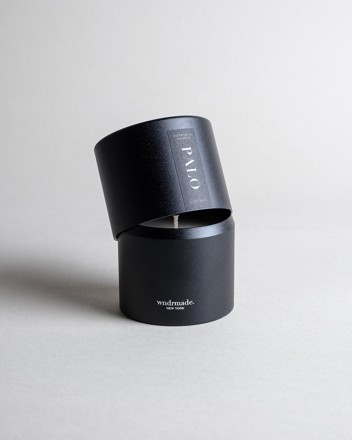 Palo Santo candle in a black minimalist tin, featuring a calming, meditative fragrance made with true Ecuadorian Palo Santo oil. Cleanses, inspires creativity, and embodies the spirit of renewal. Made with coconut/soy wax, essential oils, and botanical extracts.