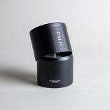 Palo Santo candle in a black minimalist tin, featuring a calming, meditative fragrance made with true Ecuadorian Palo Santo oil. Cleanses, inspires creativity, and embodies the spirit of renewal. Made with coconut/soy wax, essential oils, and botanical extracts.