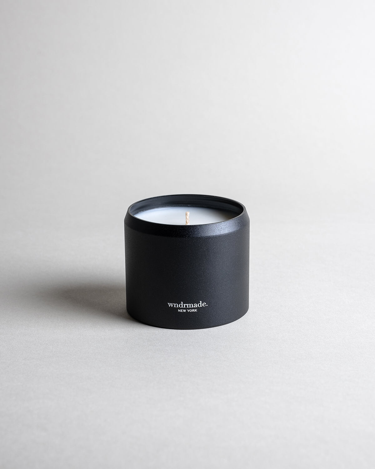 Palo Santo candle in a black minimalist tin, featuring a calming, meditative fragrance made with true Ecuadorian Palo Santo oil. Cleanses, inspires creativity, and embodies the spirit of renewal. Made with coconut/soy wax, essential oils, and botanical extracts.