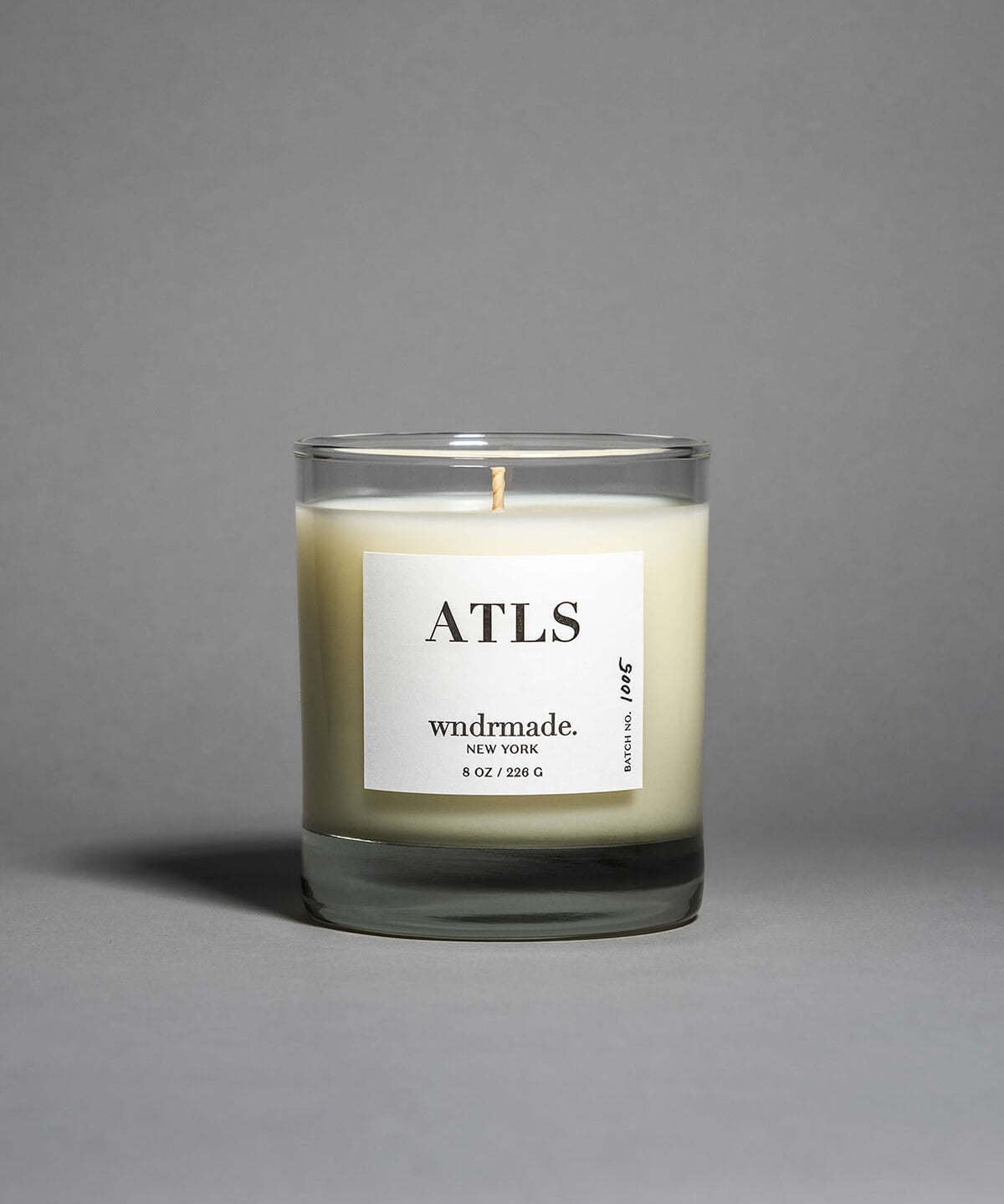 ATLAS candle in a clear heavy base glass, evoking a dreamy walk through Moroccan cedar forests with a light citrus blossom breeze. A soft, woodsy, and mildly sweet design, crafted to calm the mind. Made with coconut/soy wax, essential oils, and botanical extracts.