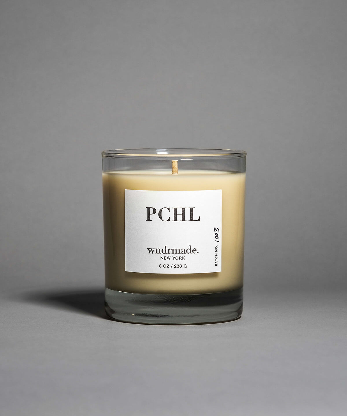 Patchouli candle in a clear heavy base glass, crafted with frankincense, juniper berry, jasmine, and more. A deep, sophisticated, and timeless aroma that redefines this enigmatic scent. Made with coconut/soy wax, essential oils, and botanical extracts.