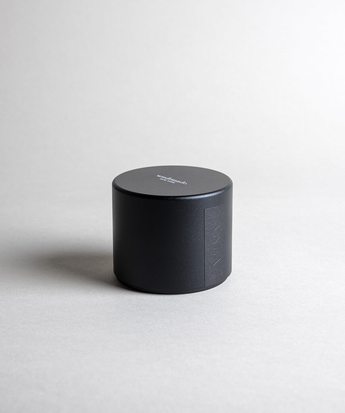 Vanilla candle in a black minimalist tin, featuring a soothing vanilla aroma with spicy, sweet, and complex notes. Ideal for relaxation, reminiscing, and creating a warm sense of home. Made with coconut/soy wax, essential oils, and botanical extracts.